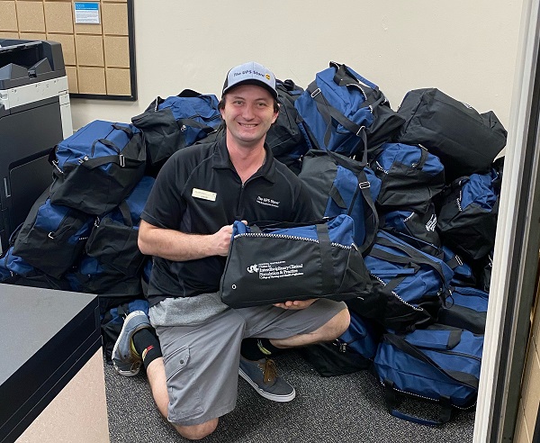 Justin Wentzel sorting student nursing bags preparing to ship to students